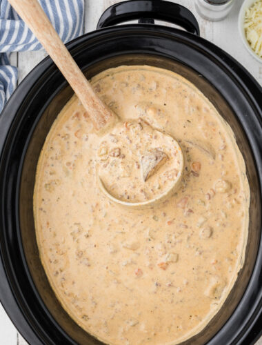 cheeseburger soup in the crockpot with a spoon in it.