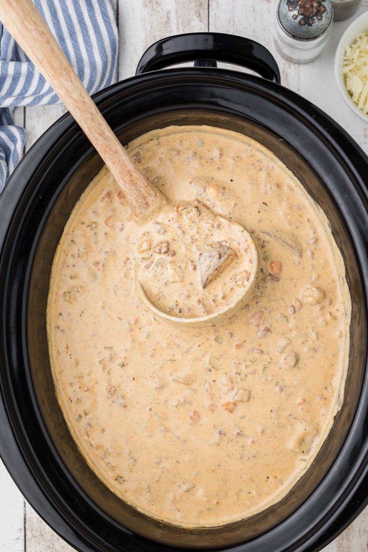 cheeseburger soup in the crockpot with a spoon in it.