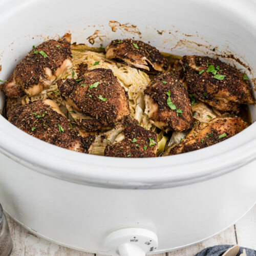 cabbage and chicken in a white slow cooker.