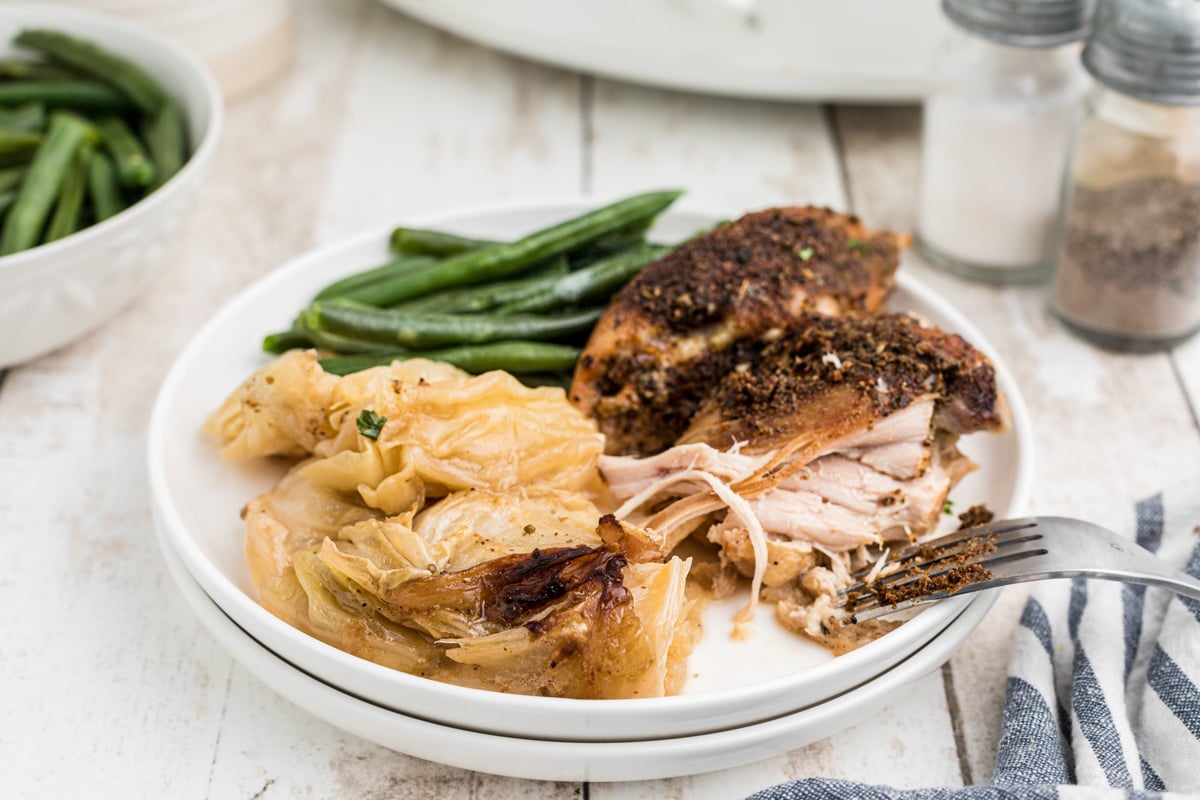 chicken and cabbage with green beans on a plate.