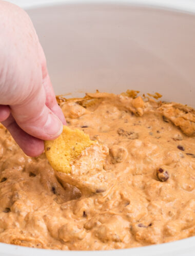 Chili cream cheese dip on a large frito.