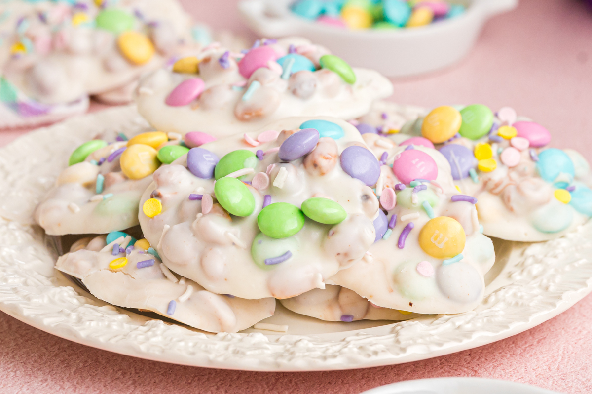 easter peanut clusters with easter colored sprinkles on a plate.