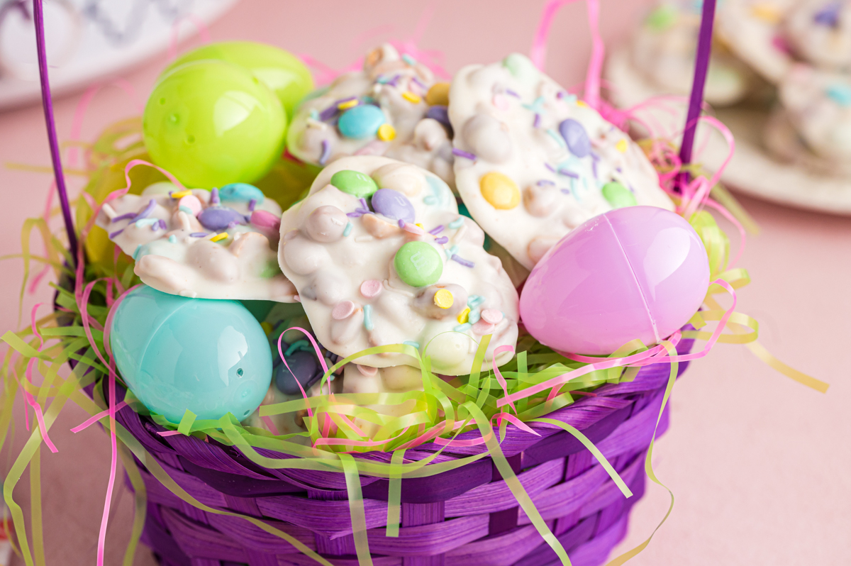 Basket filled with peanut clusters and plastic easter eggs.
