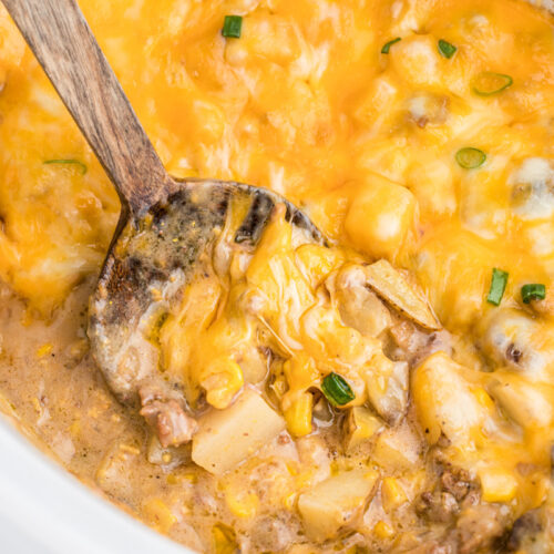 cooked hamburger hash in a white slow cooker.