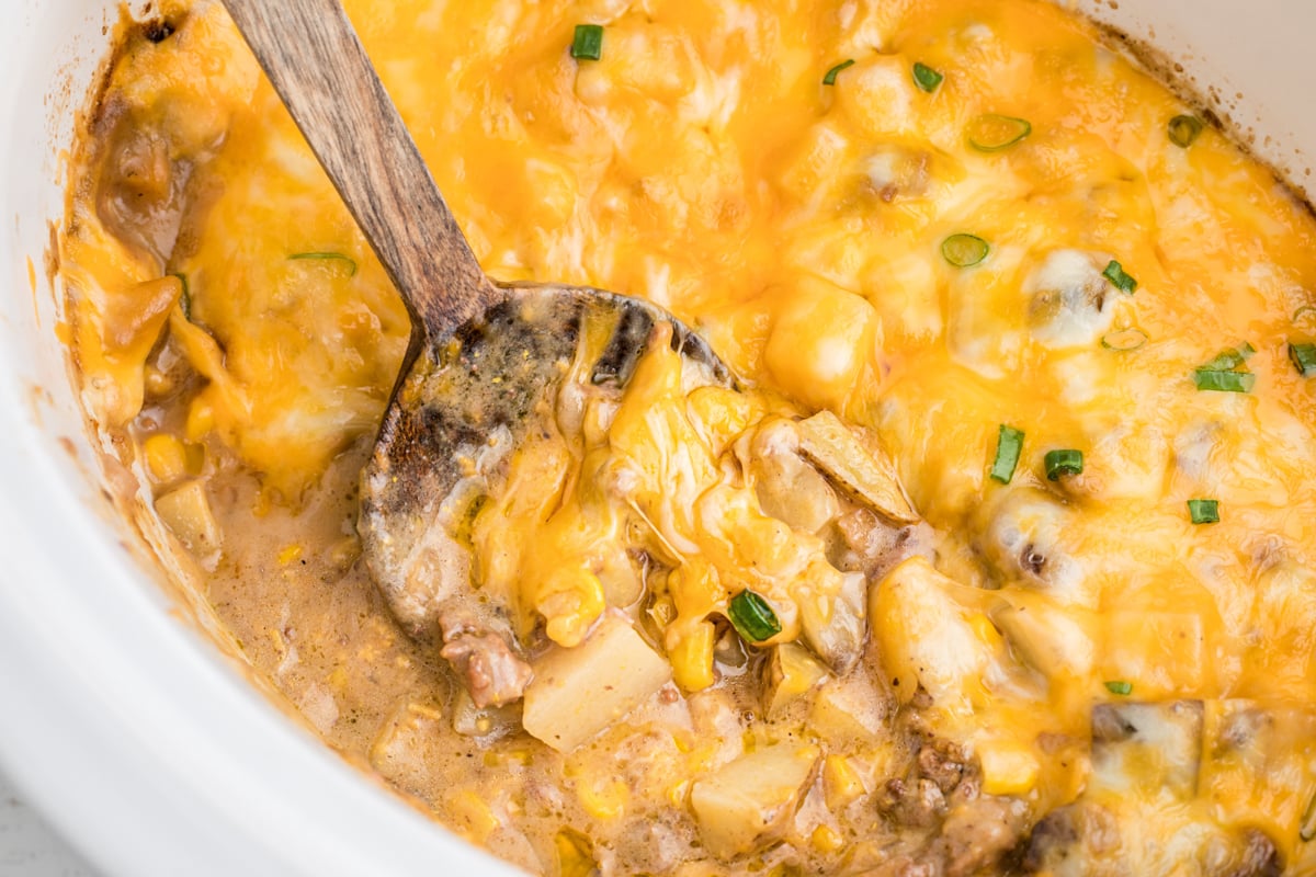 cooked hamburger hash in a white slow cooker.