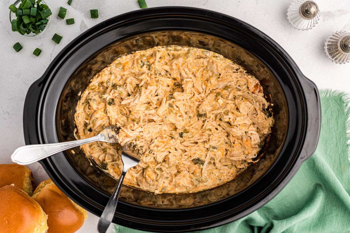 jalapeno popper chicken shredded with 2 forks in it.