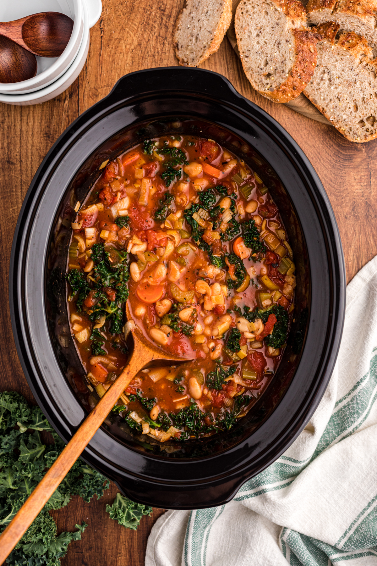 RIbollita soup in a slow cooker on a spoon.