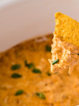 Chicken dip on a chip coming from crockpot.