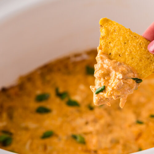 Chicken dip on a chip coming from crockpot.