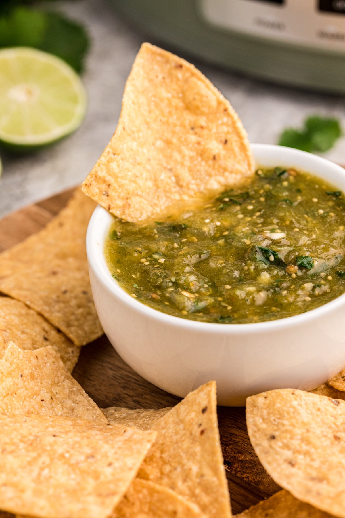 Chip in tomatillo salsa.