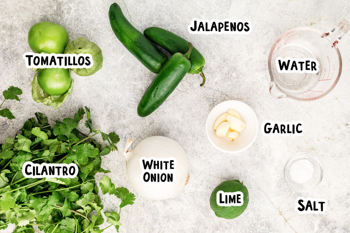 Ingredients for tomatillo salsa on a table.
