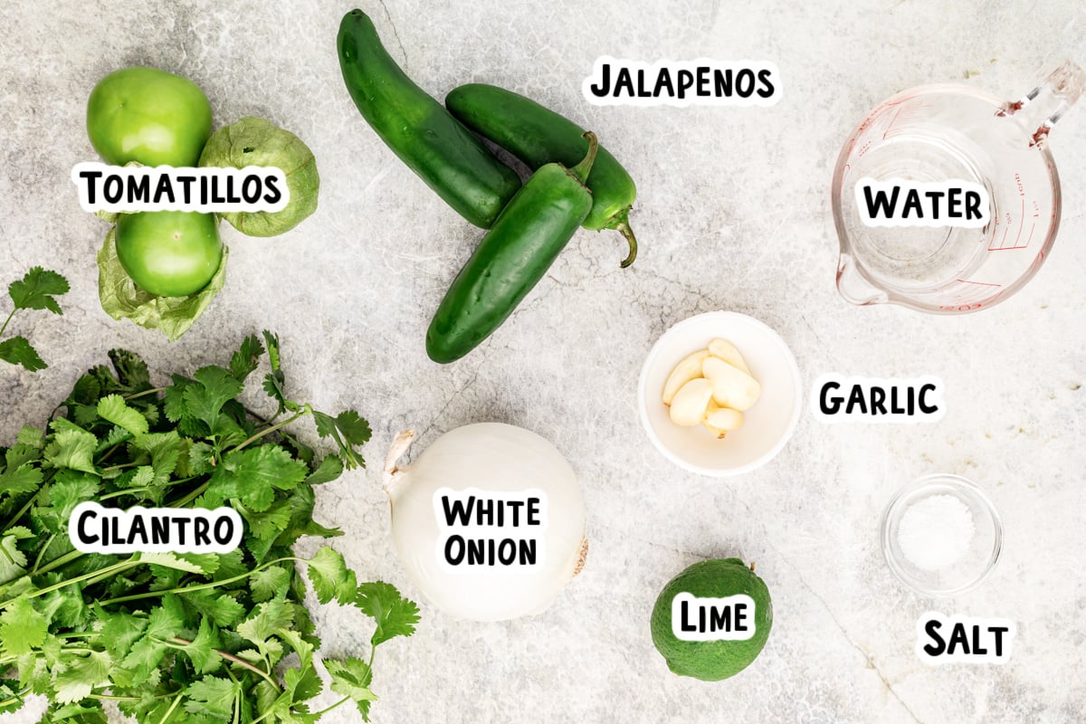 Ingredients for tomatillo salsa on a table.