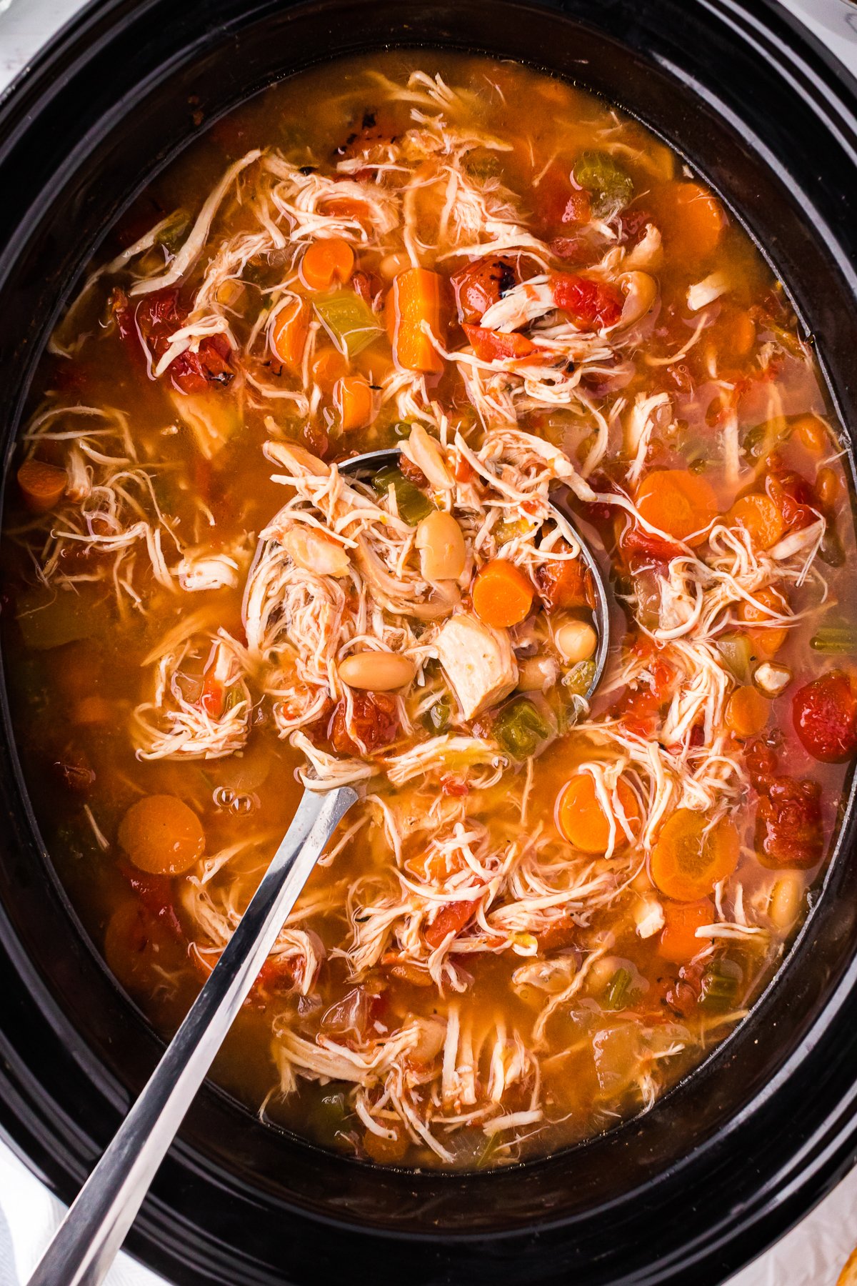 close up of tuscan white bean soup in the slow cooker.