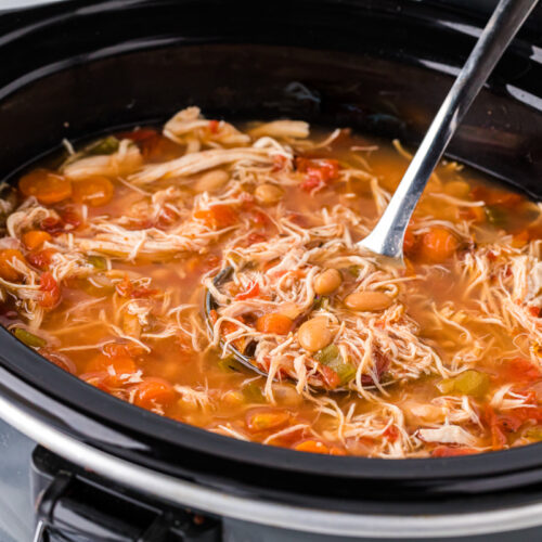 side view of tuscan bean soup in a slow cooker.