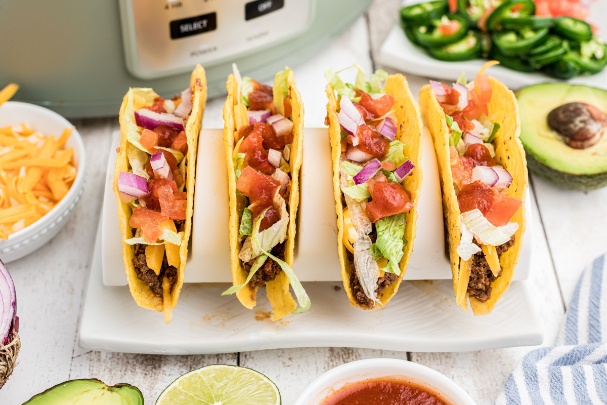 4 vension tacos on a taco stand.