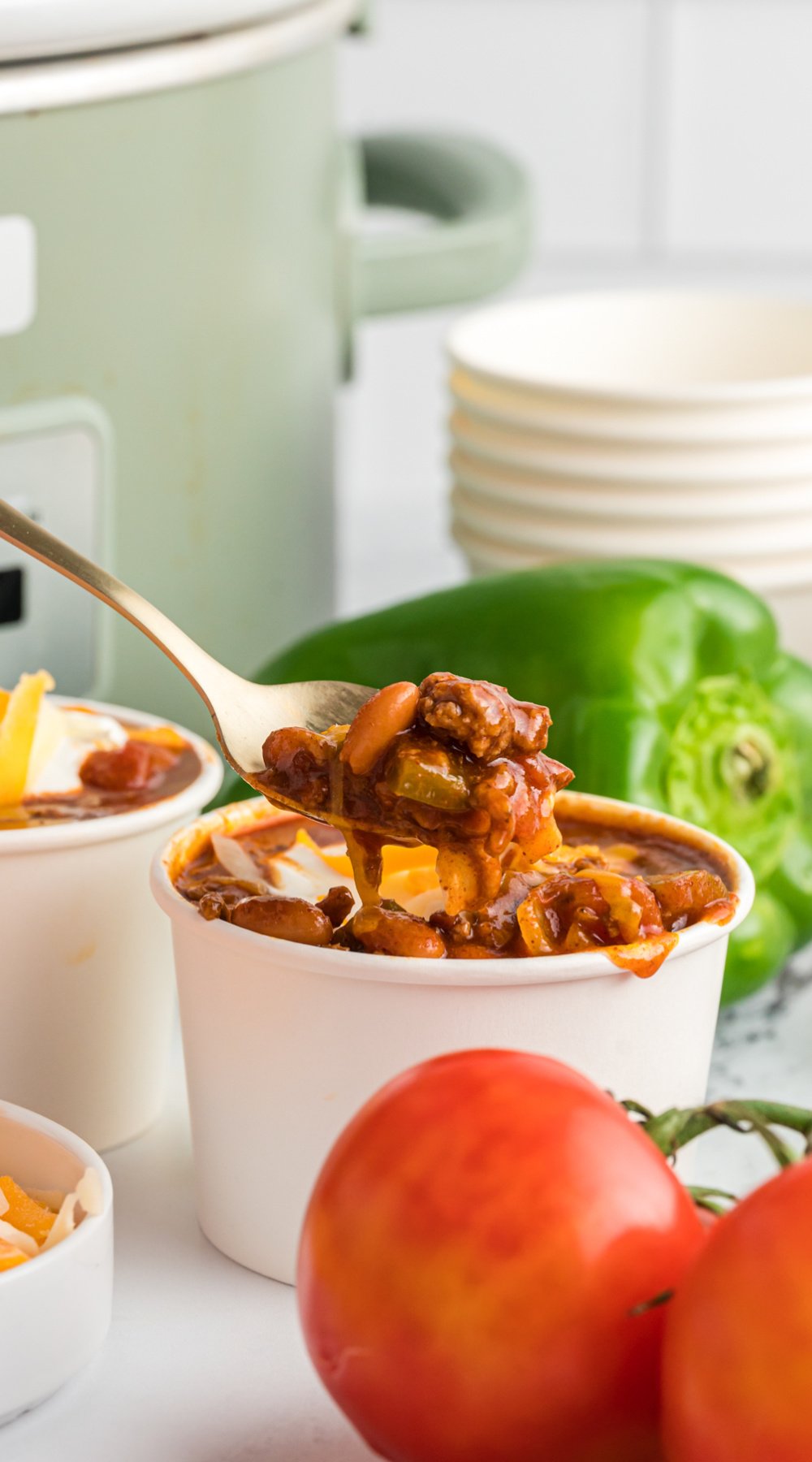 Long image of wendy's chili in a paper cup.