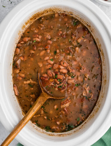 Cooked charro beans in a slow cooker.