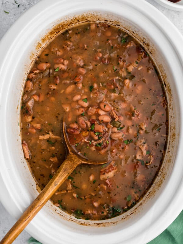 Cooked charro beans in a slow cooker.