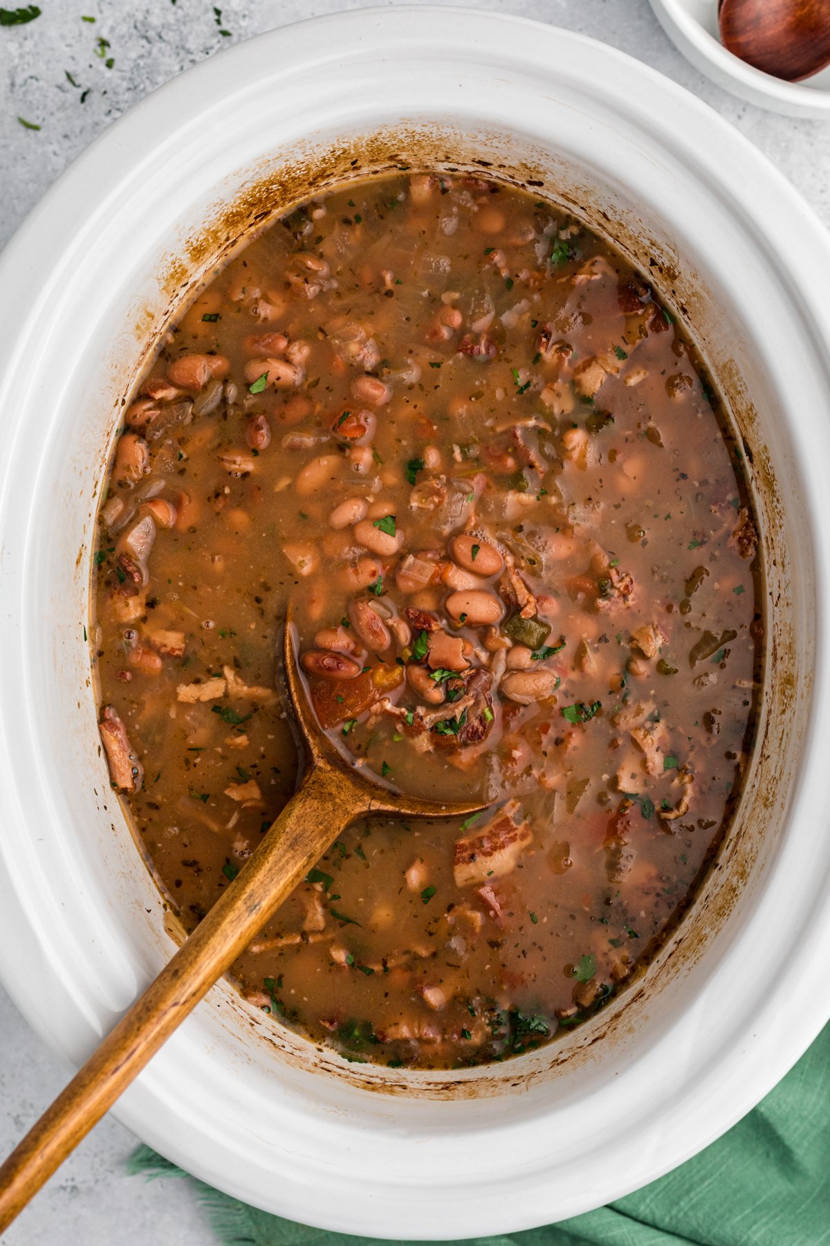 Cooked charro beans in a slow cooker.