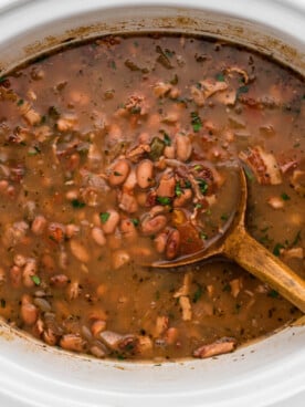 Charro beans with cilantro in a slow cooker.