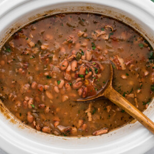 Charro beans with cilantro in a slow cooker.