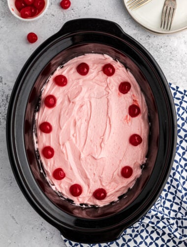 Cherry cake with frosting in a slow cooker.