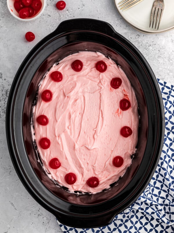 Cherry cake with frosting in a slow cooker.