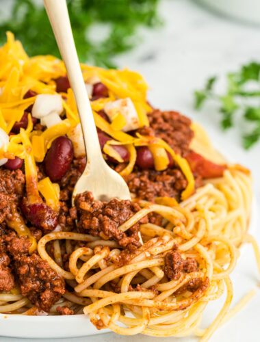 Cincinnati chili on a plate with a fork in it.