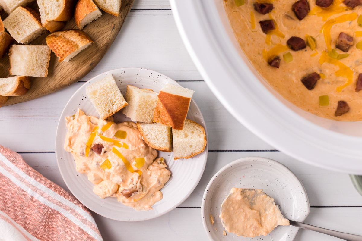 creamy dip on a plate with bread chunks.