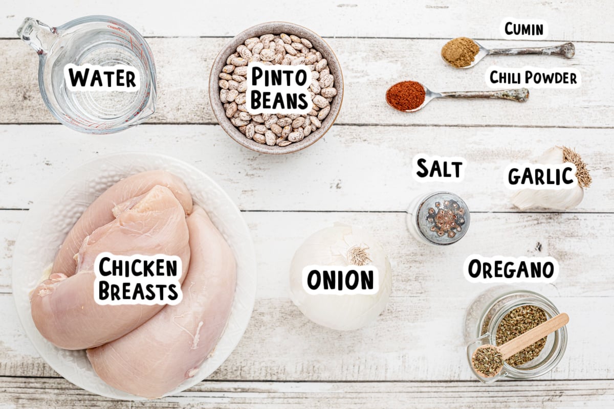 Ingredients for pinto beans and chicken on a table.