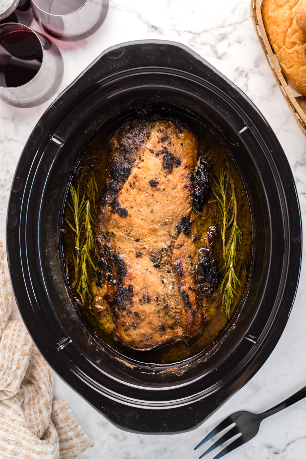 overhead of pork loin in a slow cooker after cooking.