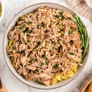overhead of slow cooker pulled pork pasta in a serving bowl.