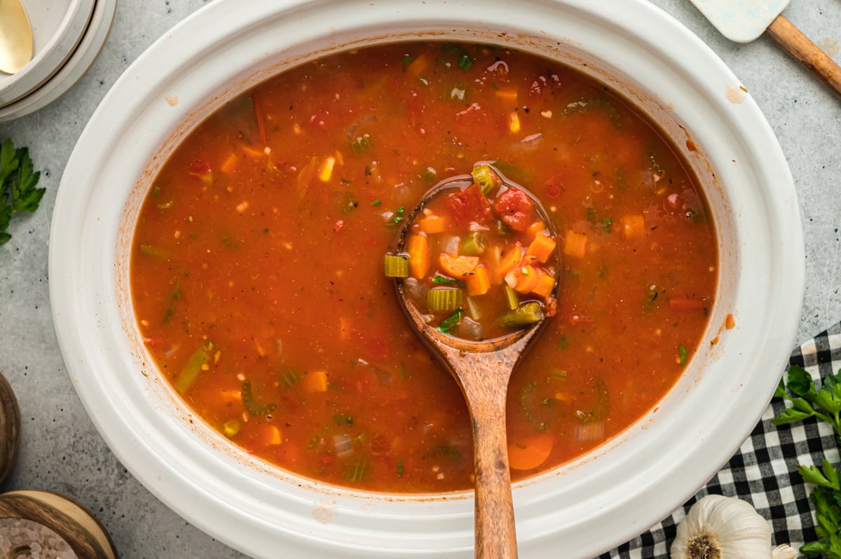 A slow cooker full of vegetable soup.