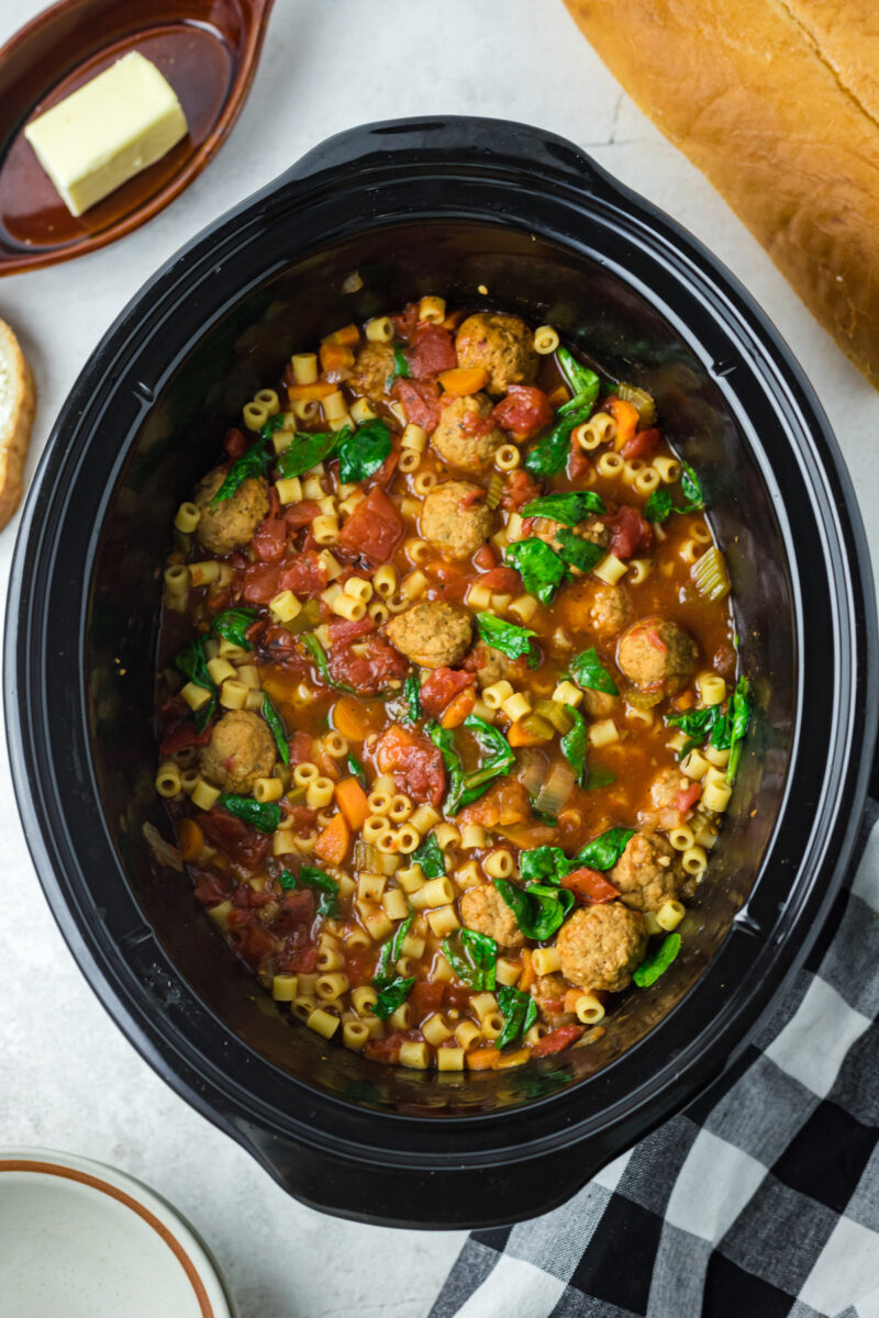 long image of meatball soup in a crockpot.