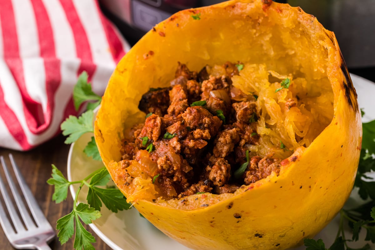 turkey meat sauce inside of a half of a spaghetti squash.