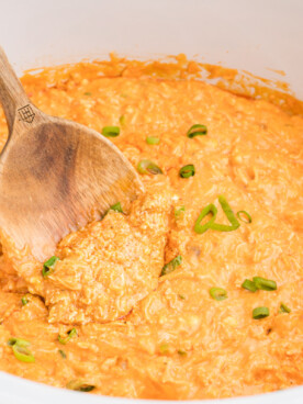 buffalo dip with a wooden spoon in it.