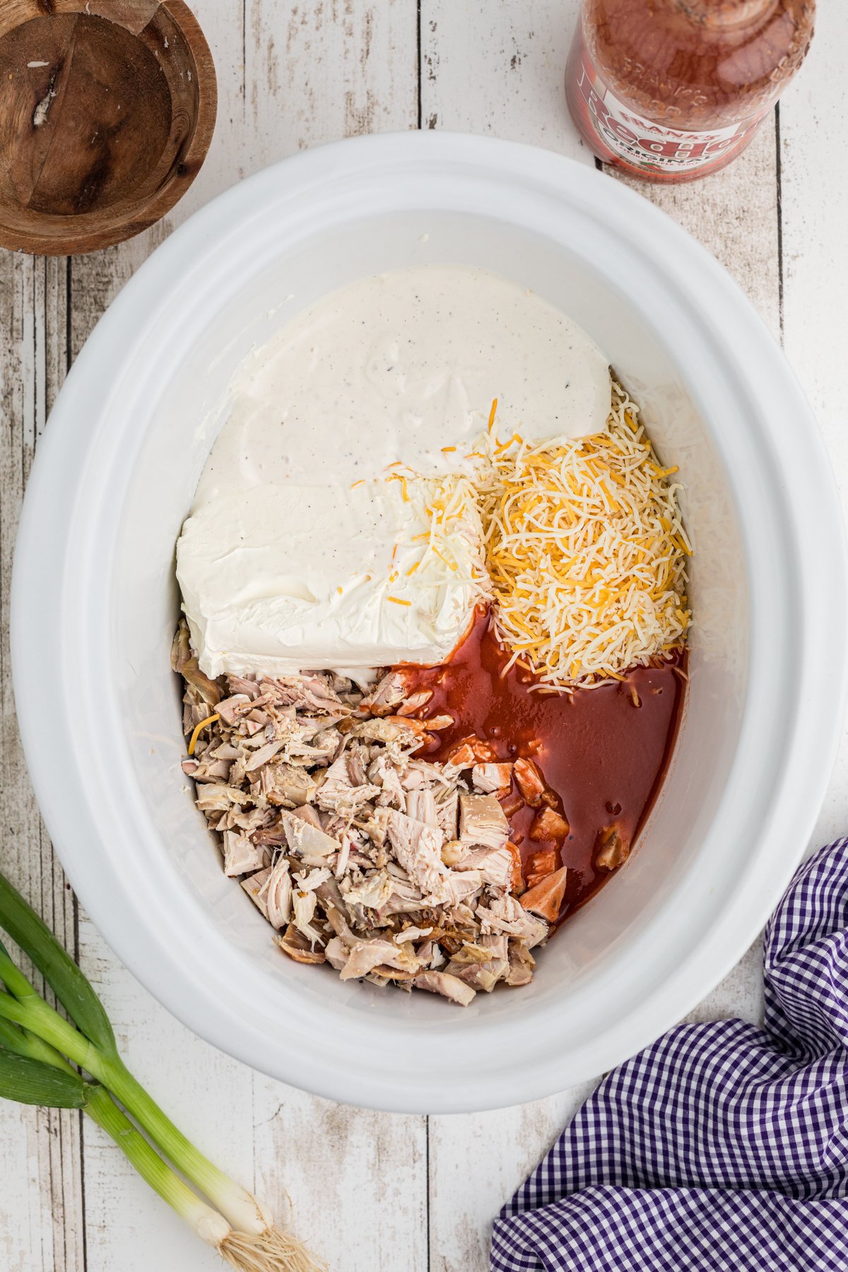 rotisserie chicken, cheese, cream cheese and buffalo sauce in a crockpot.