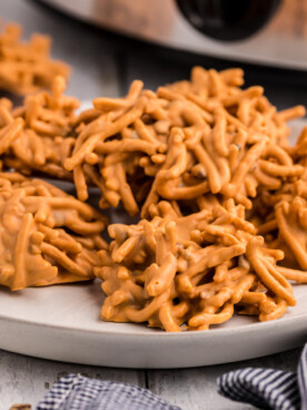 Plate of buttercotch haystacks in front of the slow cooker.