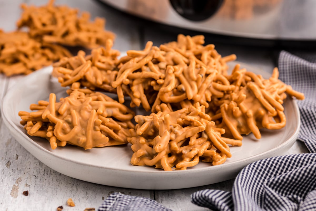 Plate of buttercotch haystacks in front of the slow cooker.