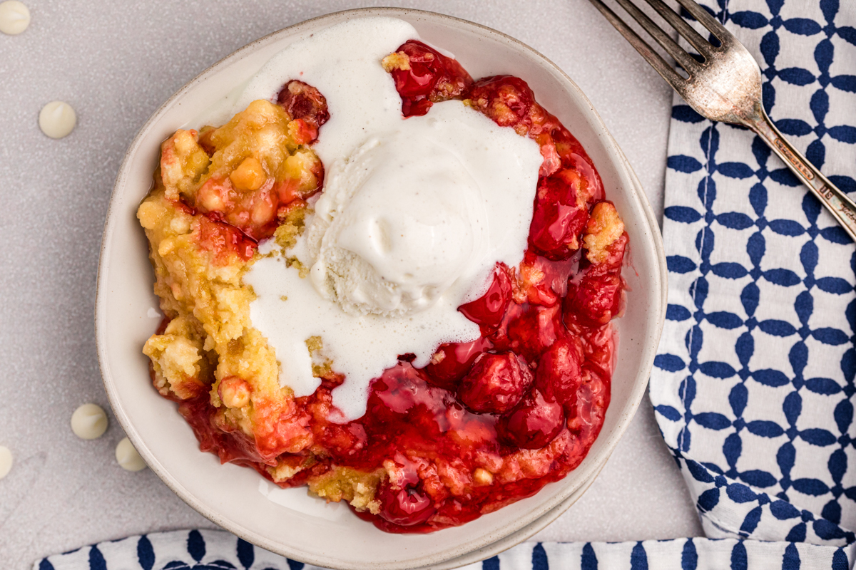 overhead shot of cherry dump cake in a bowl.