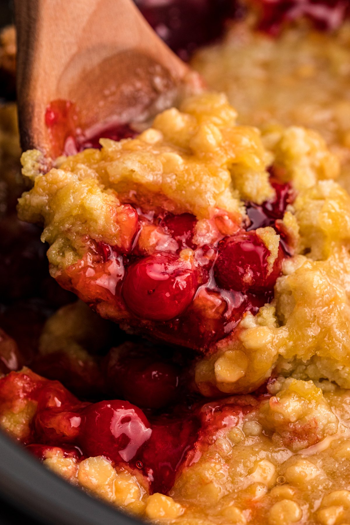cherry dump cake with white chocolate chips in a slow cooker.