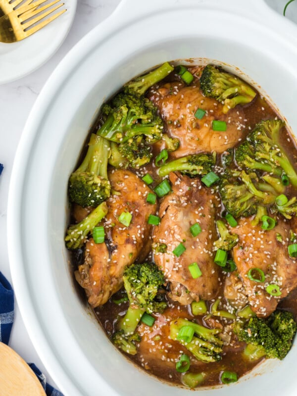 Chicken thighs and broccoli in a slow cooker.