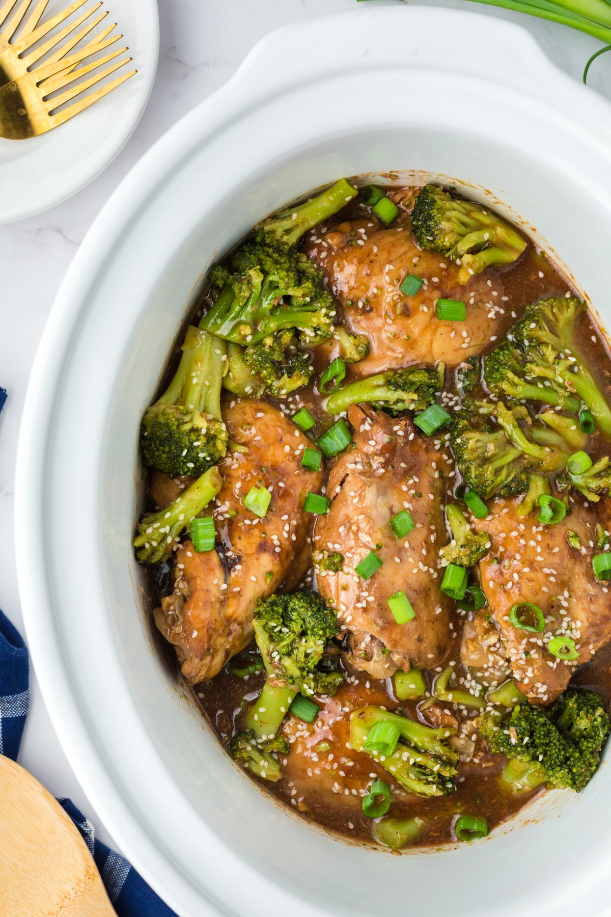 Chicken thighs and broccoli in a slow cooker.