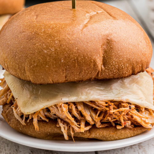 Close up of a chicken sandwich with marinara and mozzarella cheese.