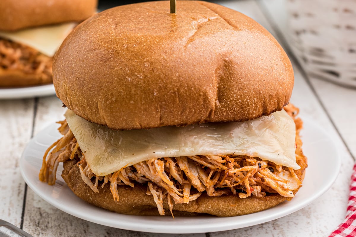 Close up of a chicken sandwich with marinara and mozzarella cheese.