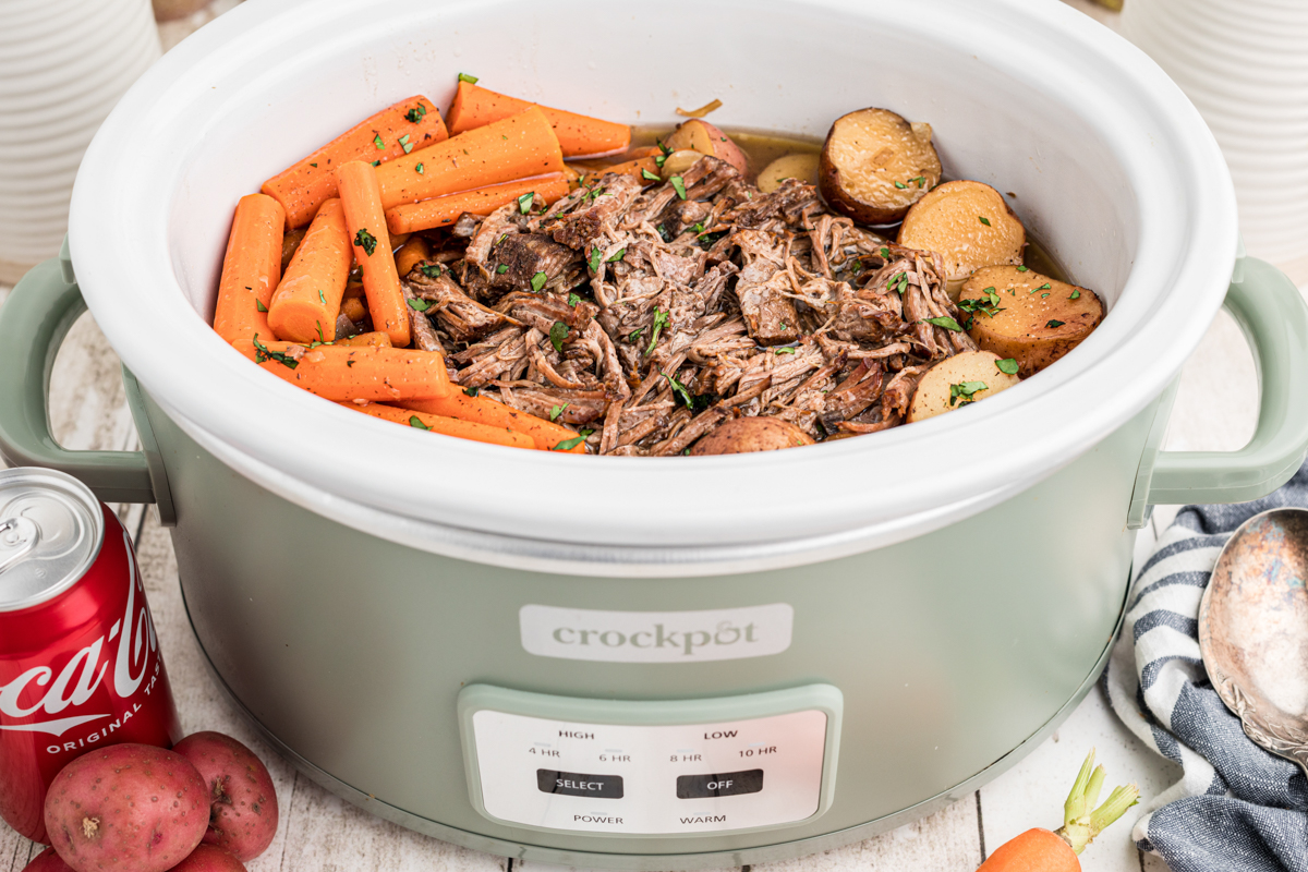 pot roast in the slow cooker with carrots, potatoes and coca cola.