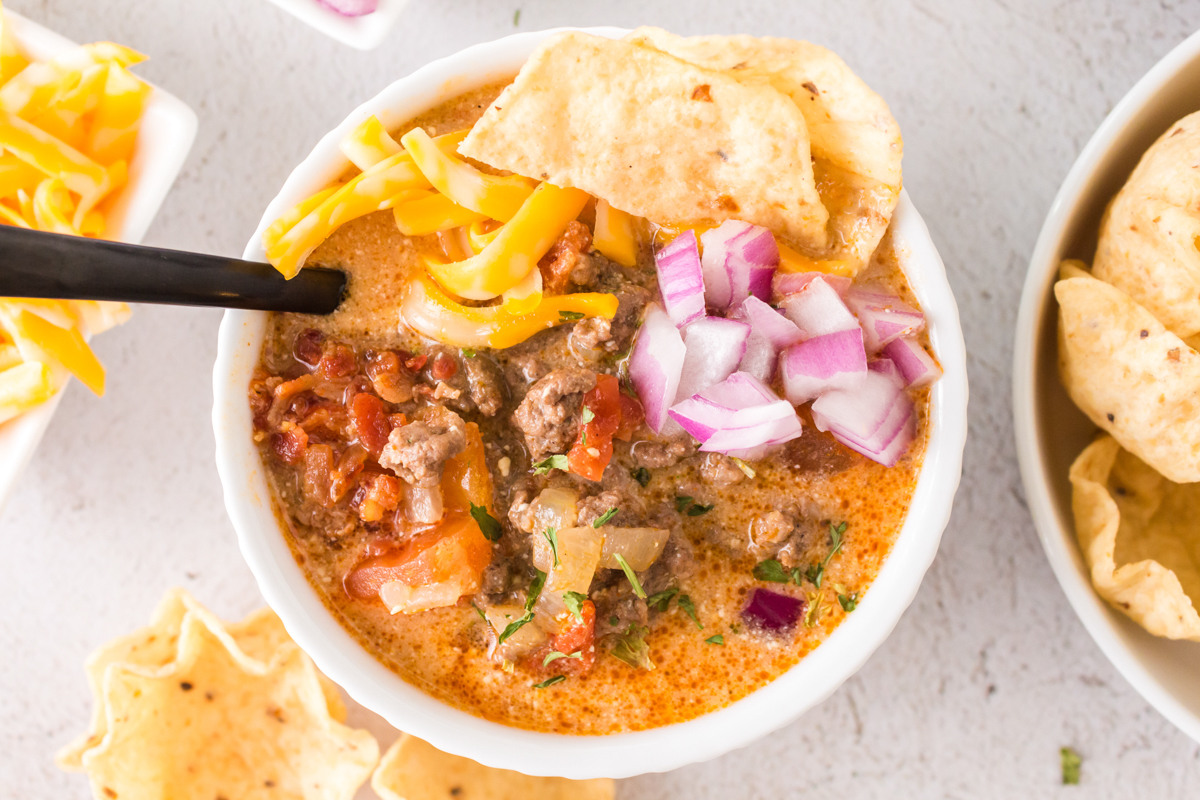 bowl of taco soup in a bowl with toppings.