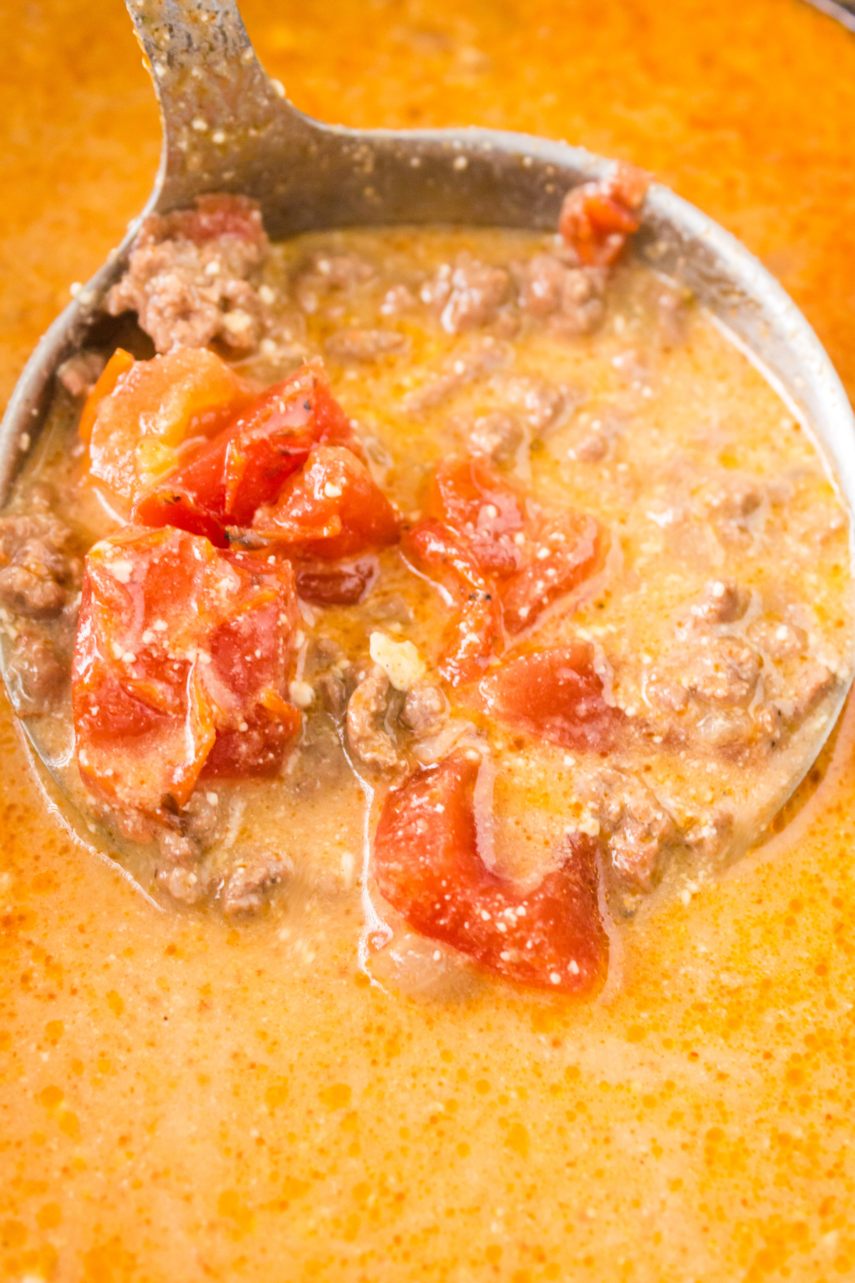 close up of taco soup in a metal spoon.