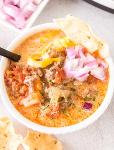 creamy taco soup in a bowl with toppings.