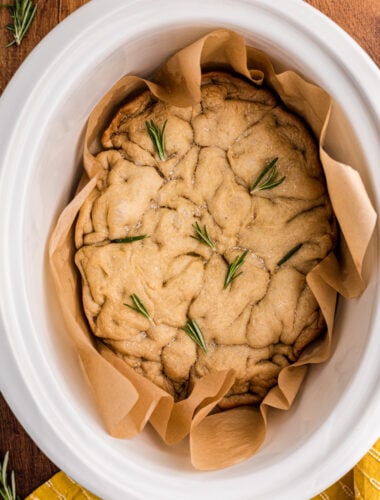close up of focaccia bread in a white slow cooker.